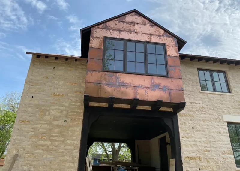 Copper metal panel facade on a stone building for Metal Roof Coating in Plains