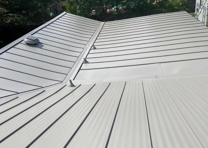 Solar attic fan installed on a metal roof for Roof Ventilation in Plains